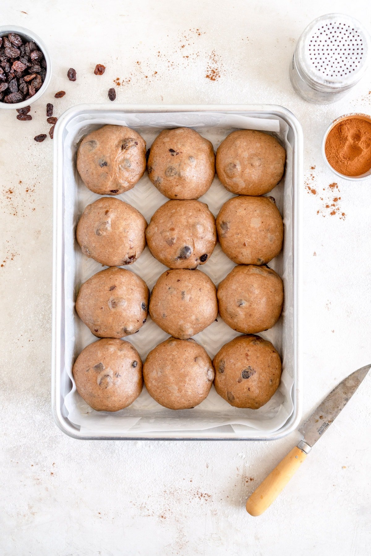 hot cross buns in pan ready to rise