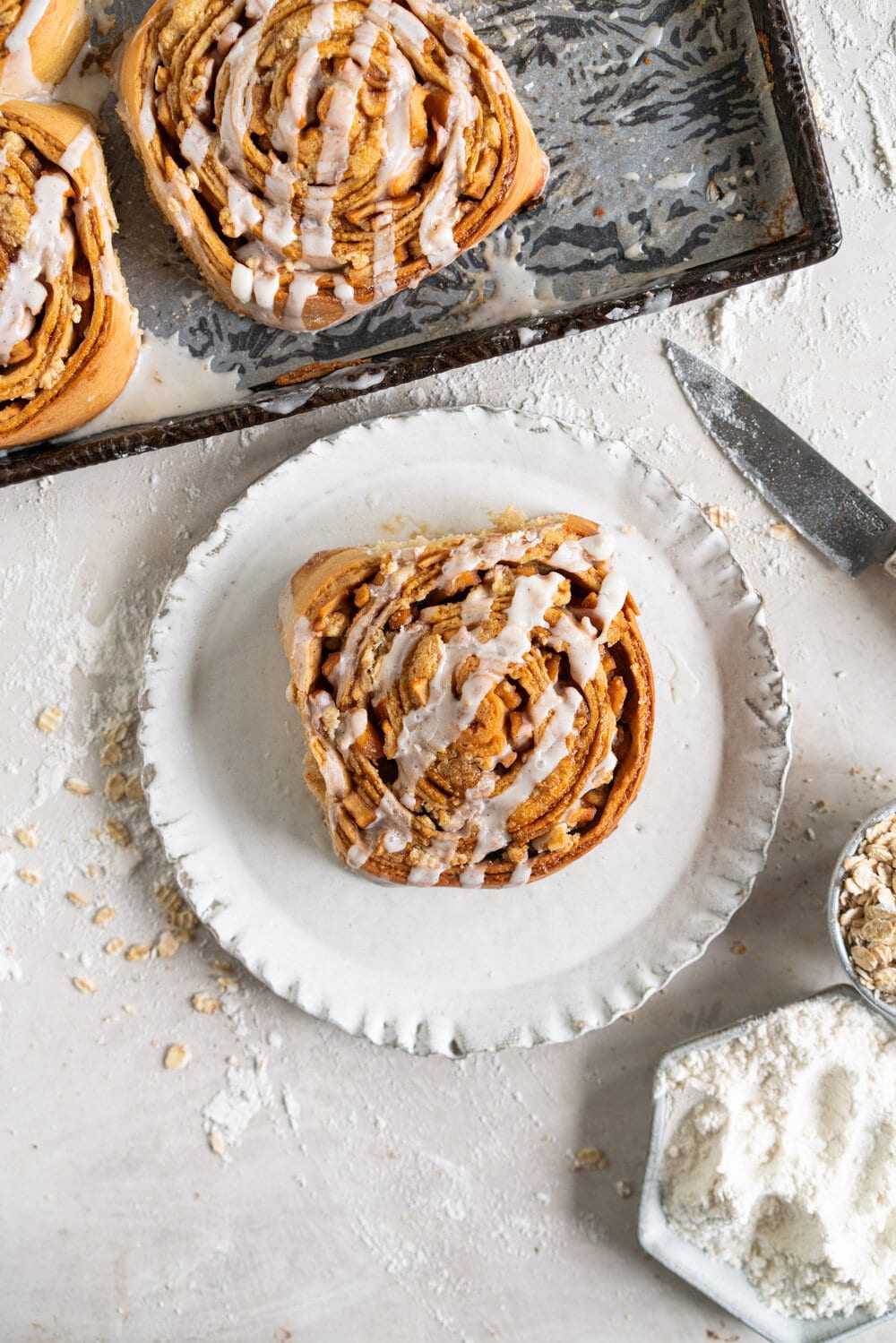 Apple Cinnamon roll with frosting on plate