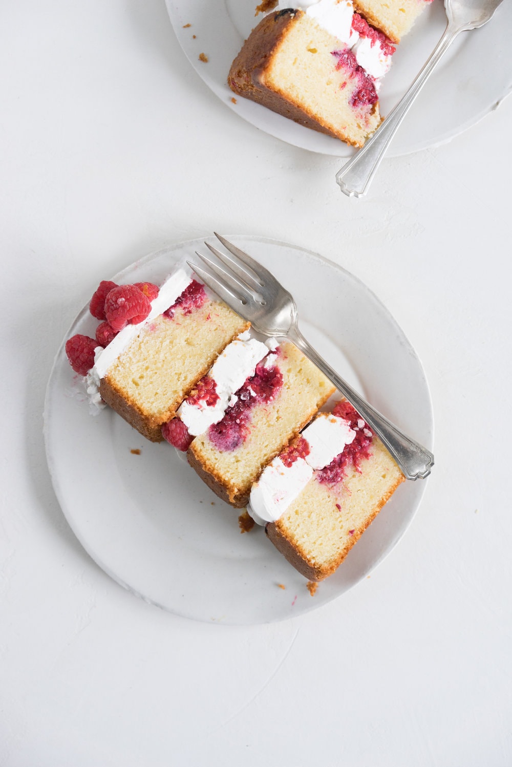 Raspberry and Almond cake - a perfectly dense almond meal cake, lightly scented with lemon, and with a layer of fresh raspberries baked into each layer. Layered with vanilla swiss meringue buttercream and more fresh raspberries. perfect for Mother's day or any other special occasion.