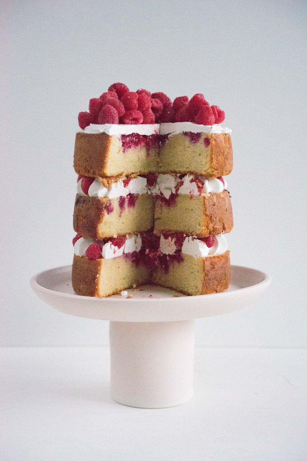 Raspberry and Almond cake - a perfectly dense almond meal cake, lightly scented with lemon, and with a layer of fresh raspberries baked into each layer. Layered with vanilla swiss meringue buttercream and more fresh raspberries. perfect for Mother's day or any other special occasion.