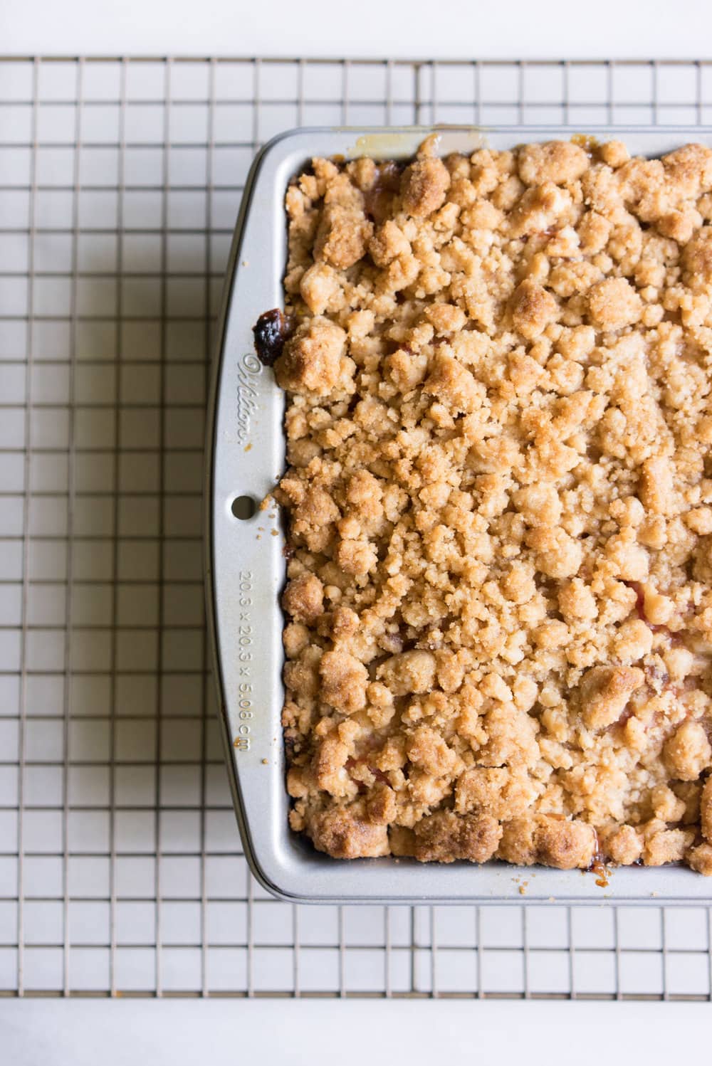 Peach and rhubarb crumb cake with brown butter streusel. This soft vanilla bean cake is covered with chopped fruit, and finished with a toasty, crunchy brown butter streusel.