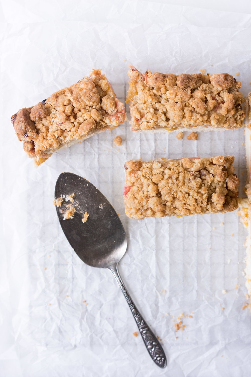 Peach and rhubarb crumb cake with brown butter streusel. This soft vanilla bean cake is covered with chopped fruit, and finished with a toasty, crunchy brown butter streusel.
