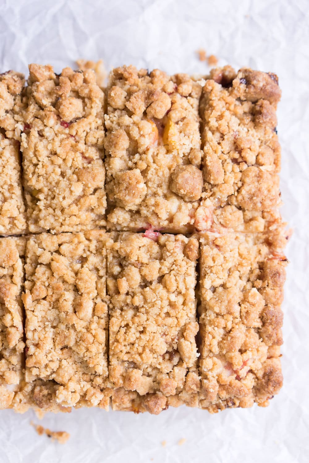 Peach and rhubarb crumb cake with brown butter streusel. This soft vanilla bean cake is covered with chopped fruit, and finished with a toasty, crunchy brown butter streusel.