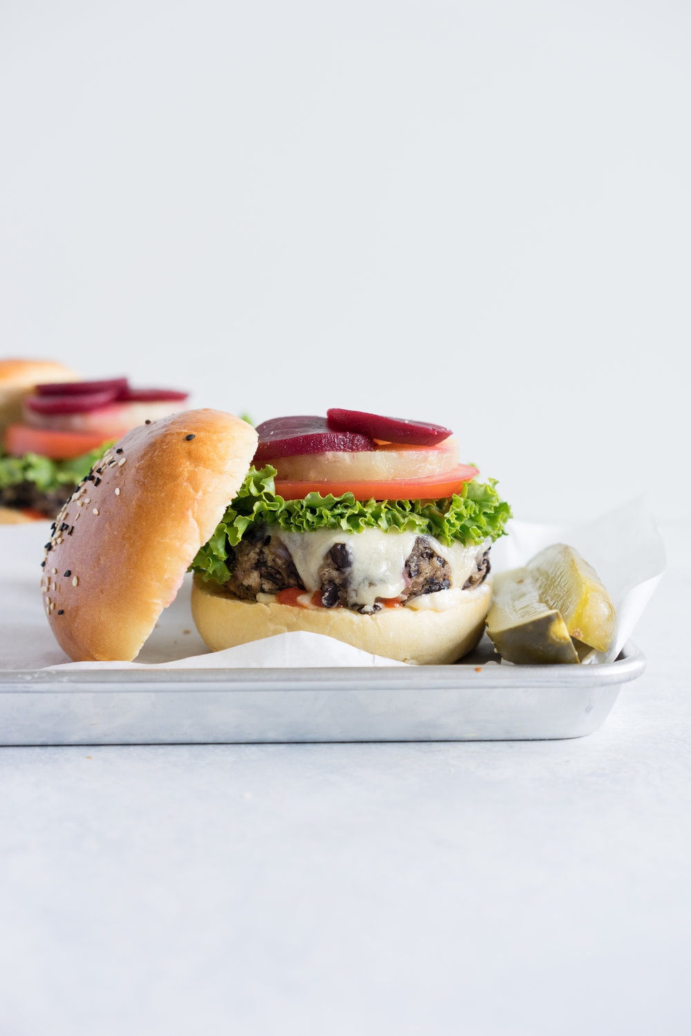 Black bean burgers with homemade brioche burger buns - the perfect vegetarian meal that even the staunchest of hamburger eater will love! #vegetarian #blackbeanburger