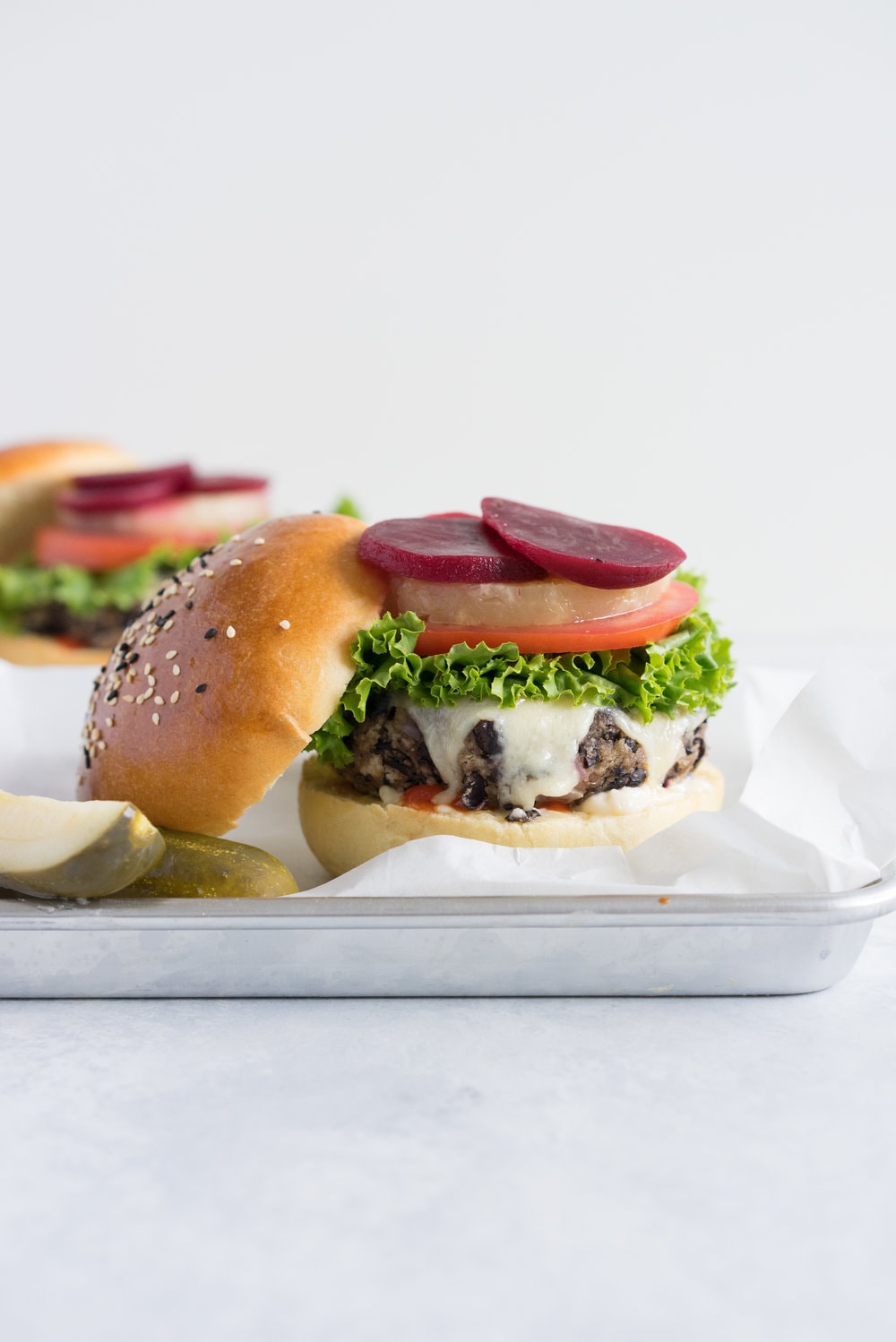 Black bean burgers with homemade brioche burger buns - the perfect vegetarian meal that even the staunchest of hamburger eater will love! #vegetarian #blackbeanburger