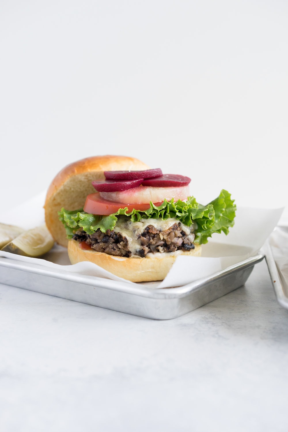 Black bean burgers with homemade brioche burger buns - the perfect vegetarian meal that even the staunchest of hamburger eater will love! #vegetarian #blackbeanburger