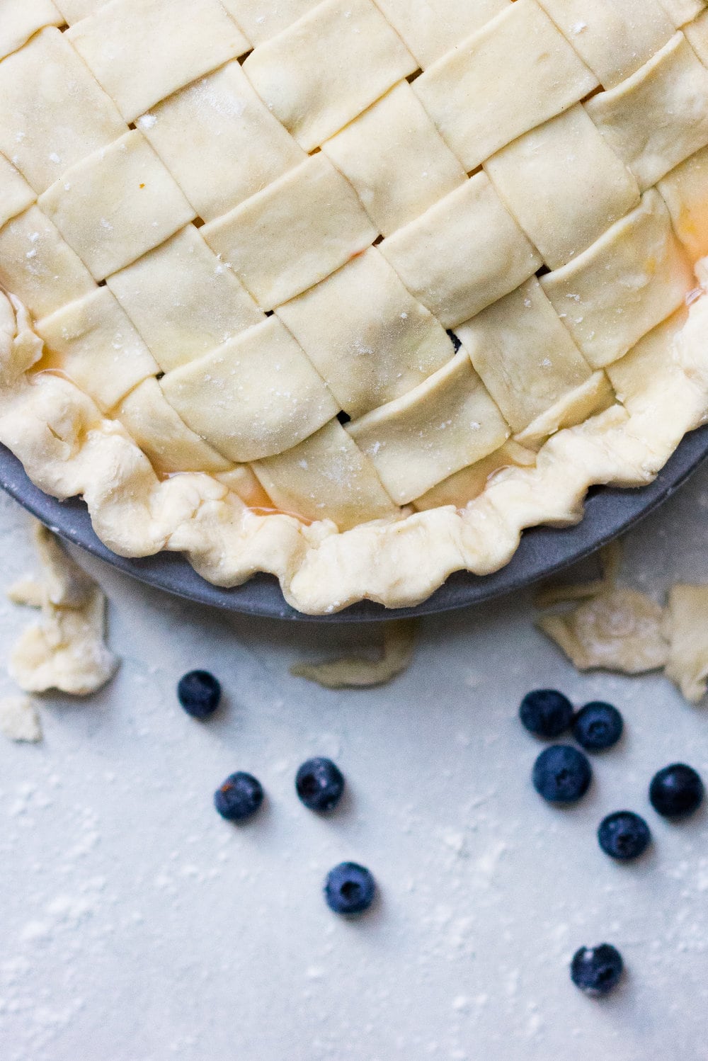 Peach and blueberry pie. The epitome of summer - flavourful fruit, held together in a flaky tender crust, elevated by a touch of sugar. The perfect summer dessert - when you have amazing fruit, you can keep things simple. #peachpie #blueberrypie #homemadepie #fruitpie #piedough #pierecipe #latticepie #peachandblueberrypie