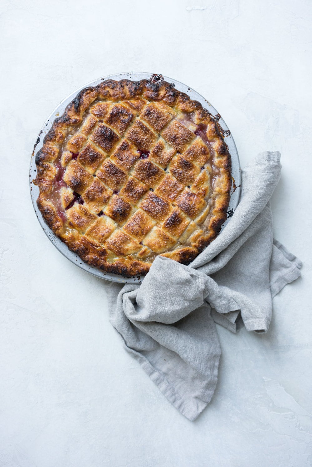 Peach and blueberry pie. The epitome of summer - flavourful fruit, held together in a flaky tender crust, elevated by a touch of sugar. The perfect summer dessert - when you have amazing fruit, you can keep things simple. #peachpie #blueberrypie #homemadepie #fruitpie #piedough #pierecipe #latticepie #peachandblueberrypie