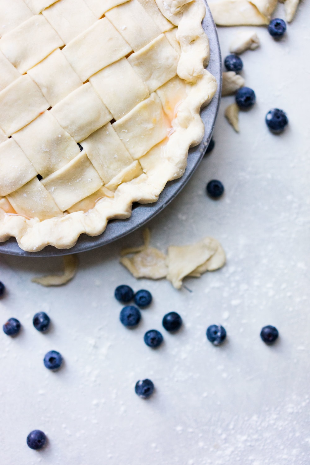 Peach and blueberry pie. The epitome of summer - flavourful fruit, held together in a flaky tender crust, elevated by a touch of sugar. The perfect summer dessert - when you have amazing fruit, you can keep things simple. #peachpie #blueberrypie #homemadepie #fruitpie #piedough #pierecipe #latticepie #peachandblueberrypie