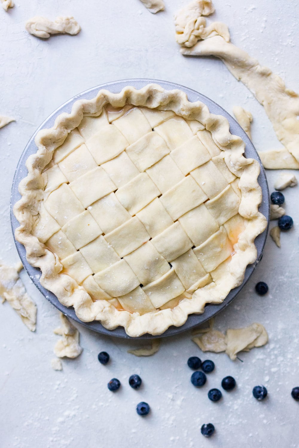Peach and blueberry pie. The epitome of summer - flavourful fruit, held together in a flaky tender crust, elevated by a touch of sugar. The perfect summer dessert - when you have amazing fruit, you can keep things simple. #peachpie #blueberrypie #homemadepie #fruitpie #piedough #pierecipe #latticepie #peachandblueberrypie
