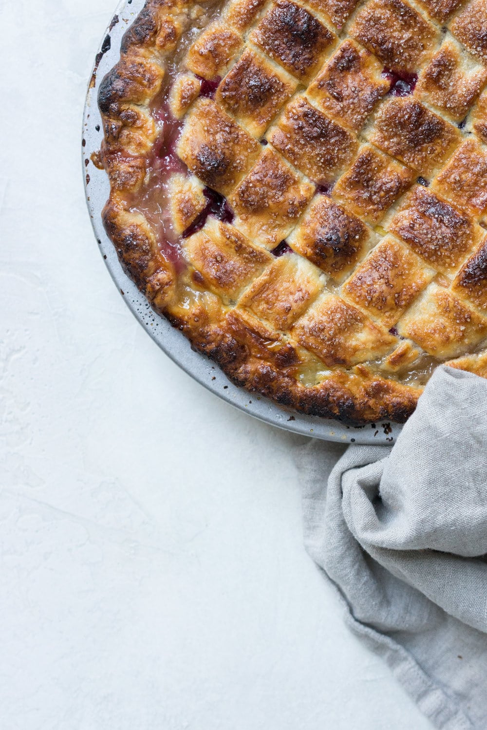 Peach and blueberry pie. The epitome of summer - flavourful fruit, held together in a flaky tender crust, elevated by a touch of sugar. The perfect summer dessert - when you have amazing fruit, you can keep things simple. #peachpie #blueberrypie #homemadepie #fruitpie #piedough #pierecipe #latticepie #peachandblueberrypie