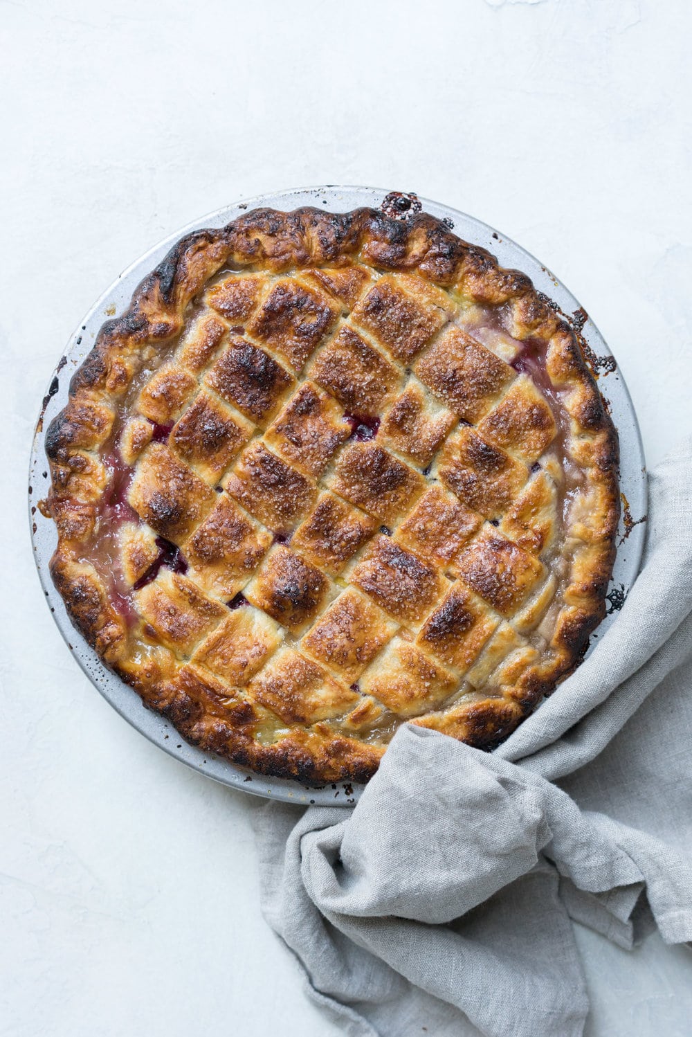 Peach and blueberry pie. The epitome of summer - flavourful fruit, held together in a flaky tender crust, elevated by a touch of sugar. The perfect summer dessert - when you have amazing fruit, you can keep things simple. #peachpie #blueberrypie #homemadepie #fruitpie #piedough #pierecipe #latticepie #peachandblueberrypie
