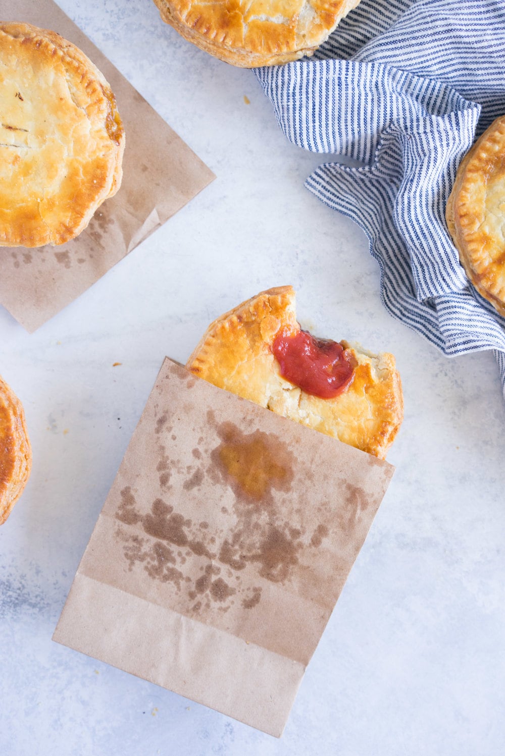 Individual steak and mushroom pies - flaky pastry encases a rich meaty filling with a flavourful gravy