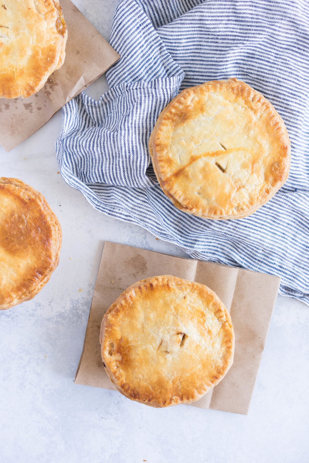 Individual steak and mushroom pies - flaky pastry encases a rich meaty filling with a flavourful gravy