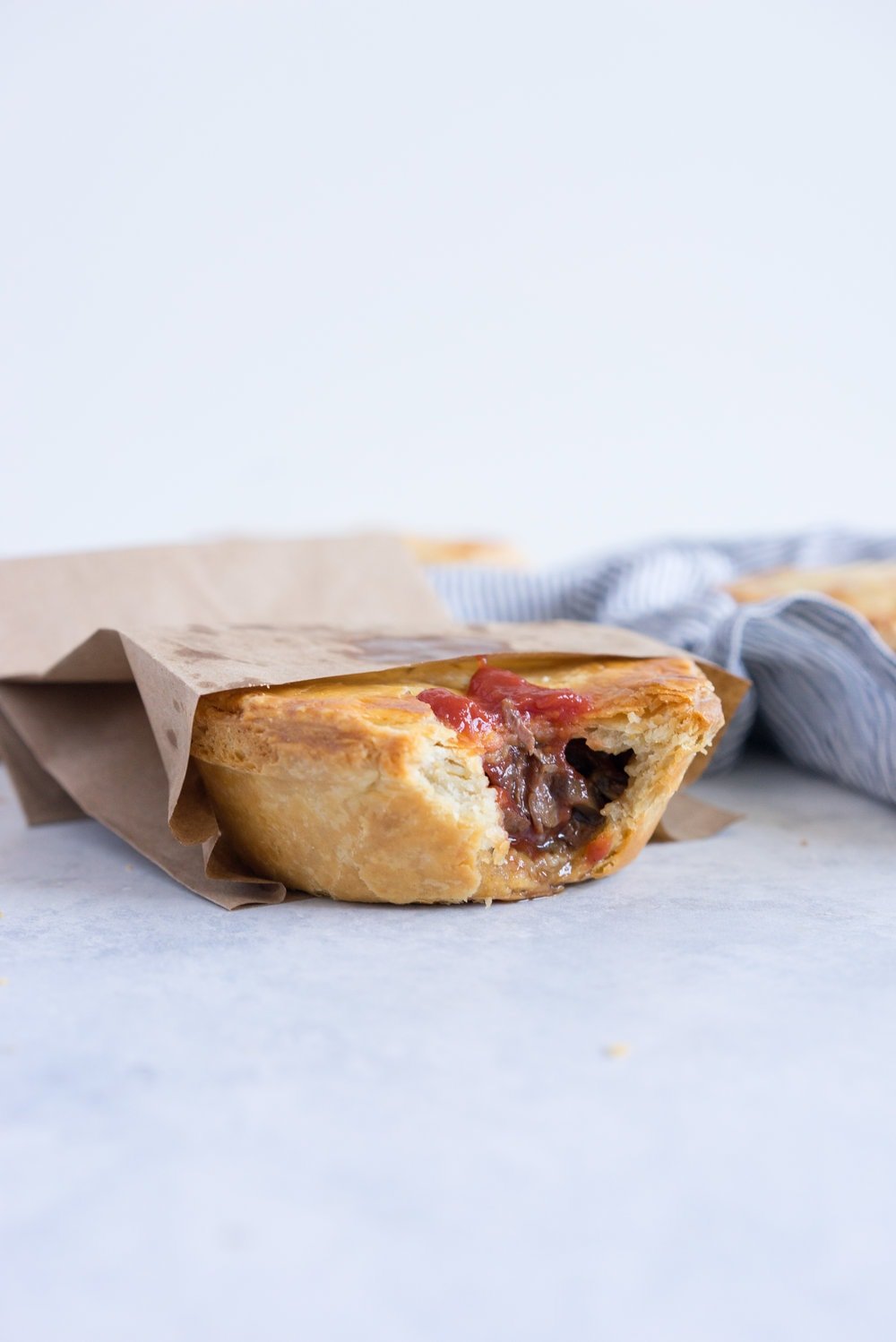 Individual steak and mushroom pies - flaky pastry encases a rich meaty filling with a flavourful gravy