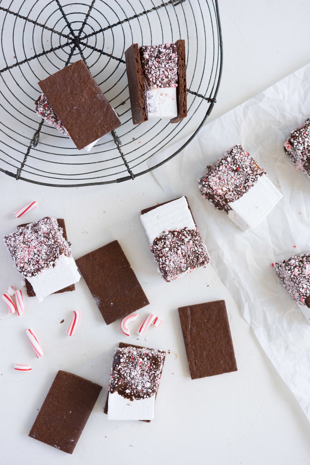 Peppermint S'mores with Chocolate Graham Crackers from Cloudy Kitchen. Puffy peppermint marshmallows are dipped in chocolate and rolled in candy canes, before being sandwiched between two chocolate graham crackers. A christmas twist on a holiday favourite