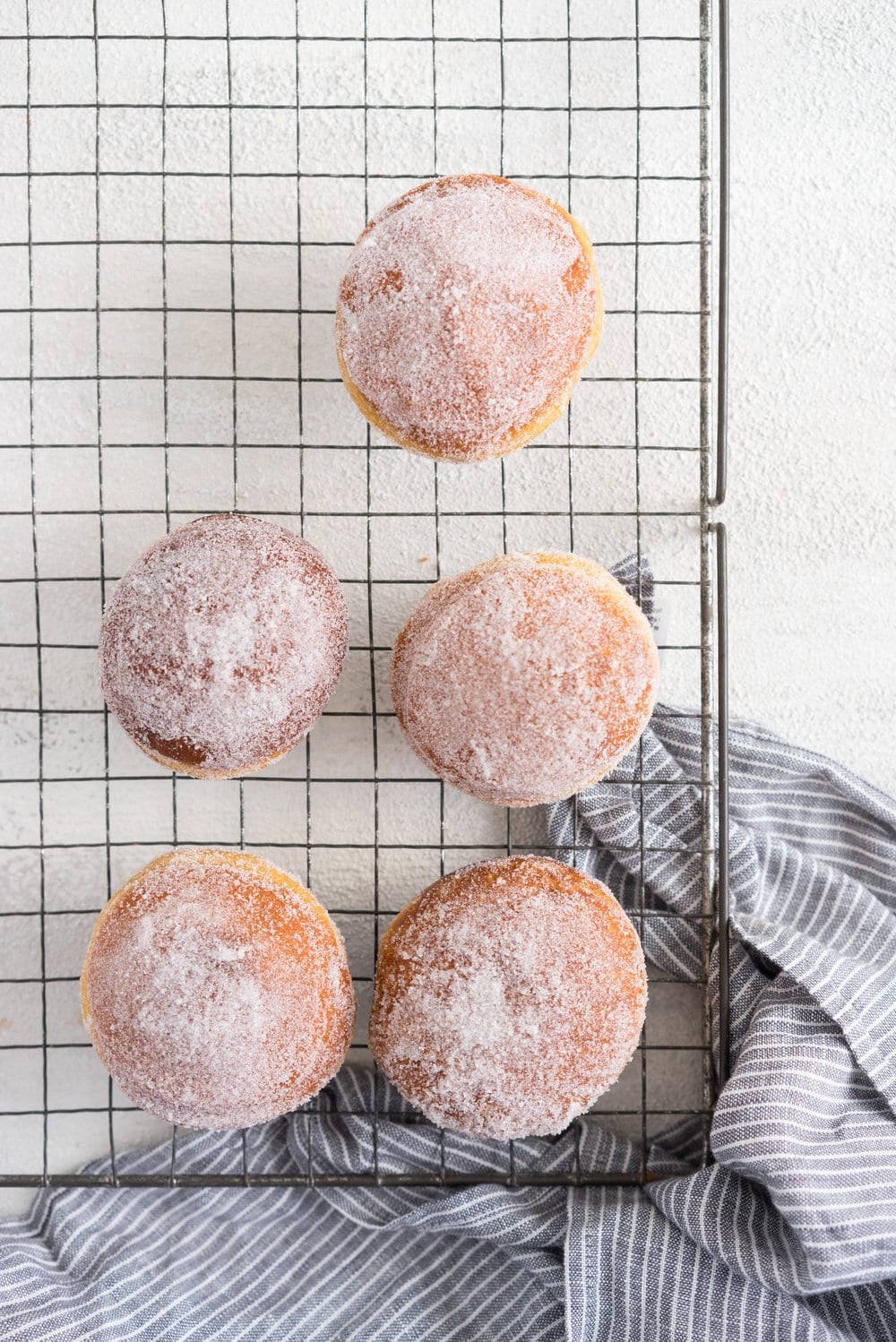 Gingerbread doughnuts with a spiced brown sugar diplomat cream. Pillowy brioche dough, spiced lightly with ginger and molasses, are stuffed with a light and creamy filling which is loaded with christmas spice. A perfect little package of holiday cheer