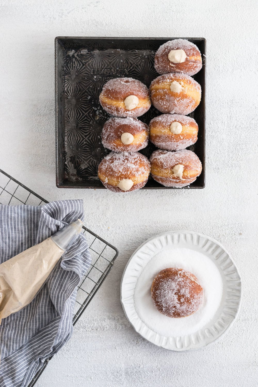 Gingerbread doughnuts with a spiced brown sugar diplomat cream. Pillowy brioche dough, spiced lightly with ginger and molasses, are stuffed with a light and creamy filling which is loaded with christmas spice. A perfect little package of holiday cheer