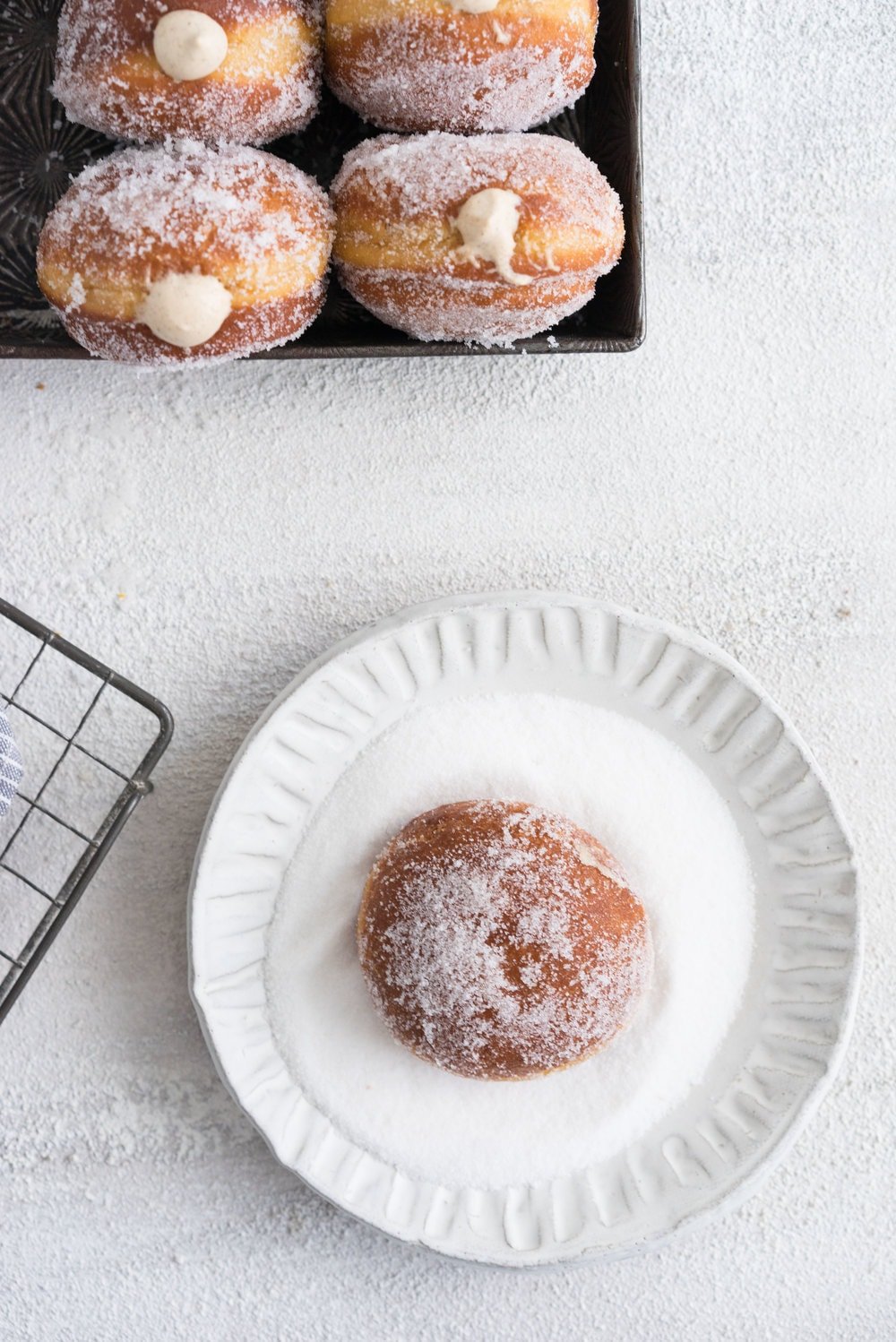 Gingerbread doughnuts with a spiced brown sugar diplomat cream. Pillowy brioche dough, spiced lightly with ginger and molasses, are stuffed with a light and creamy filling which is loaded with christmas spice. A perfect little package of holiday cheer