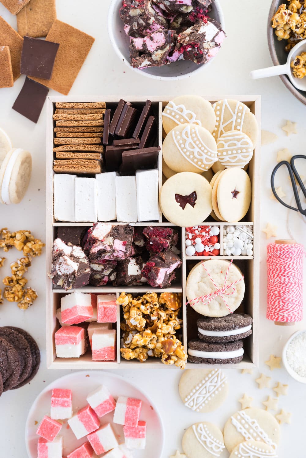 THE ultimate holiday cookie box - with something for everyone. Coconut ice, Honey Caramel Corn, sugar cookie marshmallow sandwiches, marshmallow and sugar cookie rocky road, piped roll out sugar cookies, and a DIY S'mores kit. What more could you wish for - this would be the perfect gift this holiday season.