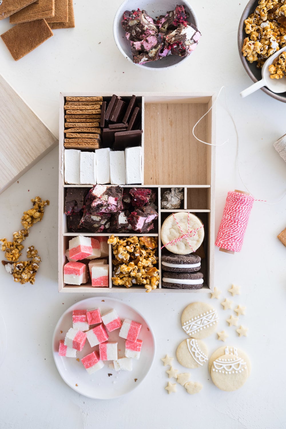 THE ultimate holiday cookie box - with something for everyone. Coconut ice, Honey Caramel Corn, sugar cookie marshmallow sandwiches, marshmallow and sugar cookie rocky road, piped roll out sugar cookies, and a DIY S'mores kit. What more could you wish for - this would be the perfect gift this holiday season.