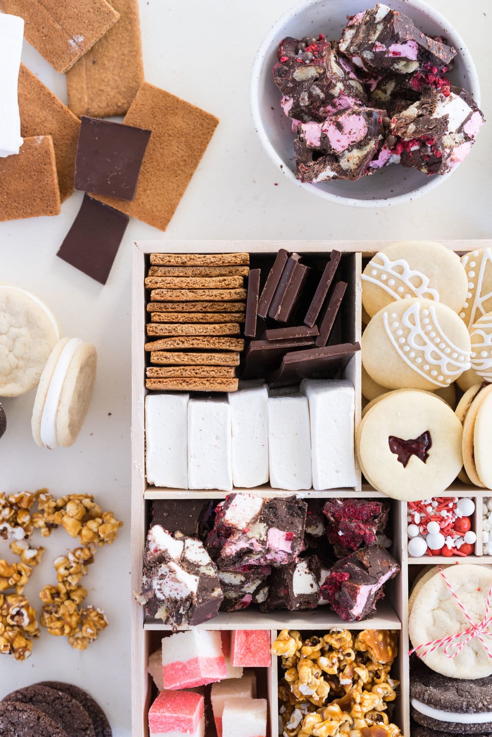 THE ultimate holiday cookie box - with something for everyone. Coconut ice, Honey Caramel Corn, sugar cookie marshmallow sandwiches, marshmallow and sugar cookie rocky road, piped roll out sugar cookies, and a DIY S'mores kit. What more could you wish for - this would be the perfect gift this holiday season.