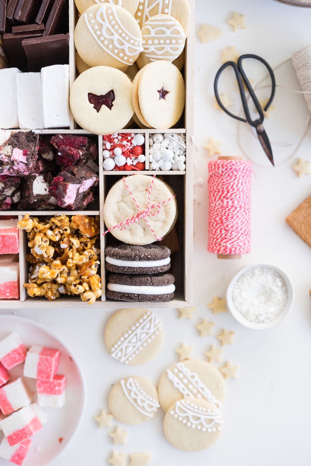 THE ultimate holiday cookie box - with something for everyone. Coconut ice, Honey Caramel Corn, sugar cookie marshmallow sandwiches, marshmallow and sugar cookie rocky road, piped roll out sugar cookies, and a DIY S'mores kit. What more could you wish for - this would be the perfect gift this holiday season.