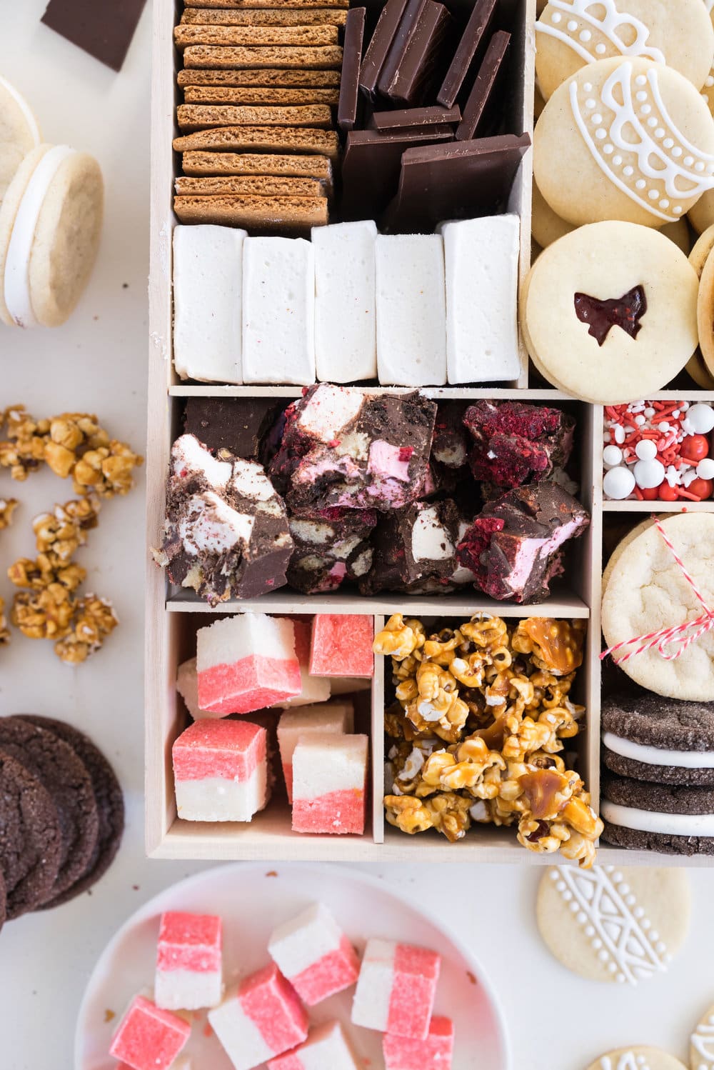 THE ultimate holiday cookie box - with something for everyone. Coconut ice, Honey Caramel Corn, sugar cookie marshmallow sandwiches, marshmallow and sugar cookie rocky road, piped roll out sugar cookies, and a DIY S'mores kit. What more could you wish for - this would be the perfect gift this holiday season.