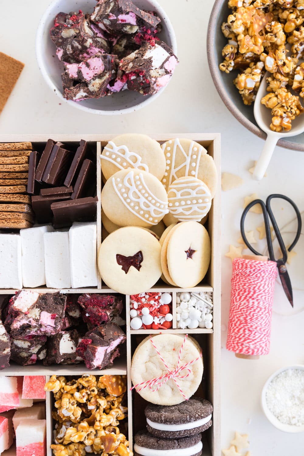 THE ultimate holiday cookie box - with something for everyone. Coconut ice, Honey Caramel Corn, sugar cookie marshmallow sandwiches, marshmallow and sugar cookie rocky road, piped roll out sugar cookies, and a DIY S'mores kit. What more could you wish for - this would be the perfect gift this holiday season.