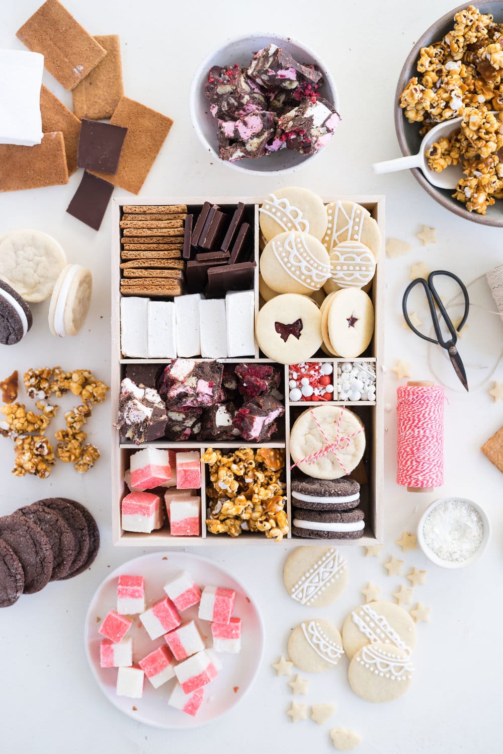 THE ultimate holiday cookie box - with something for everyone. Coconut ice, Honey Caramel Corn, sugar cookie marshmallow sandwiches, marshmallow and sugar cookie rocky road, piped roll out sugar cookies, and a DIY S'mores kit. What more could you wish for - this would be the perfect gift this holiday season.