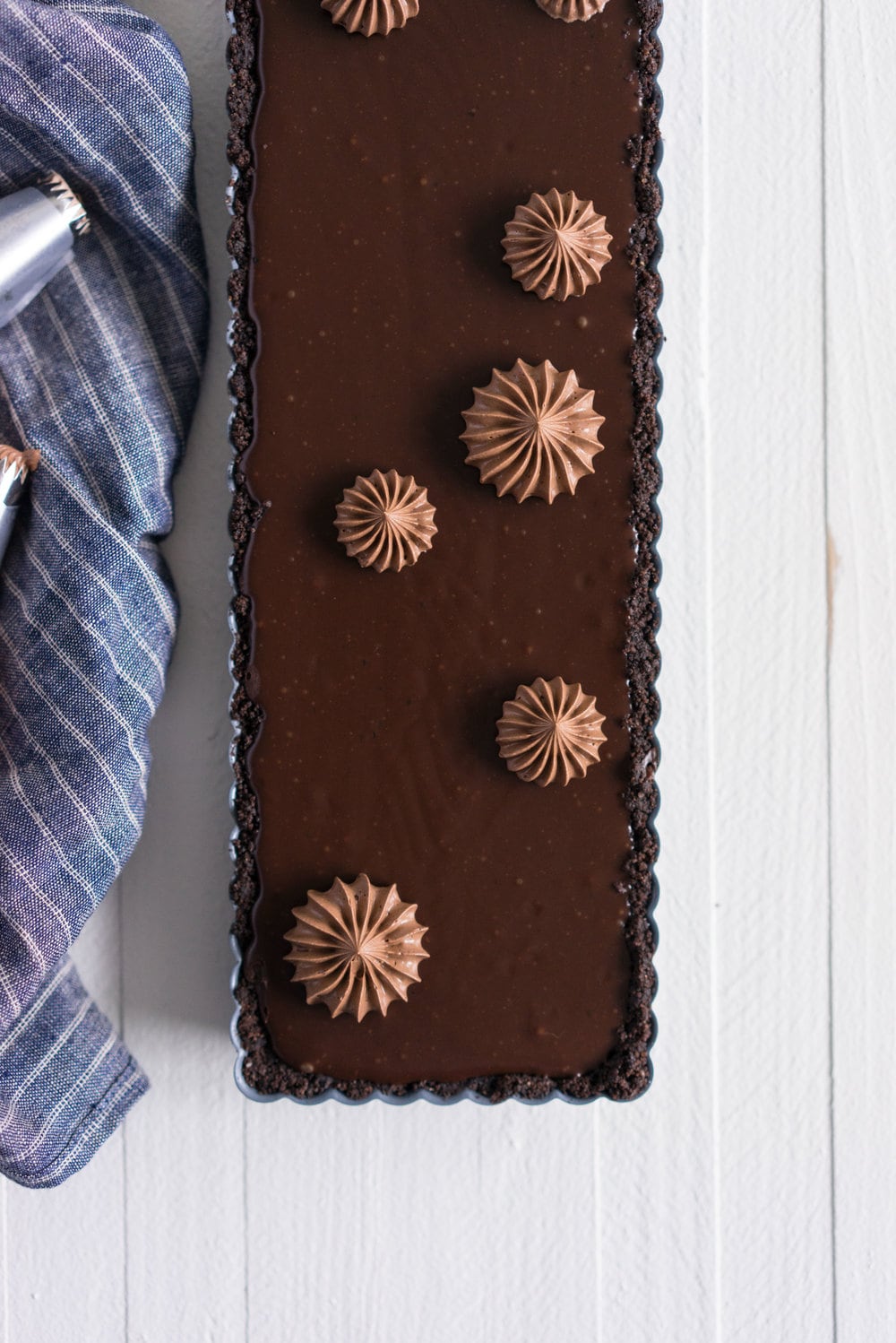 Milk Chocolate Earl Grey Tart with Ombre Dark Chocolate Swiss Meringue Buttercream. A press in cookie crust is topped with a silky earl grey infused ganache filling, then finished with an ombre swiss meringue buttercream.