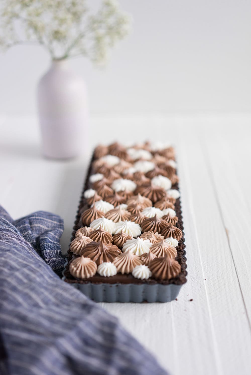 Milk Chocolate Earl Grey Tart with Ombre Dark Chocolate Swiss Meringue Buttercream. A press in cookie crust is topped with a silky earl grey infused ganache filling, then finished with an ombre swiss meringue buttercream.