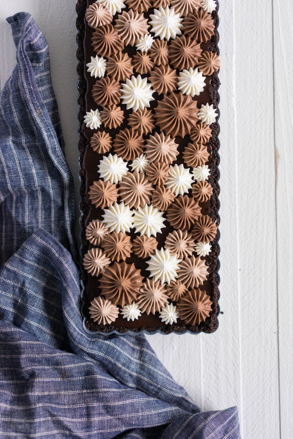 Milk Chocolate Earl Grey Tart with Ombre Dark Chocolate Swiss Meringue Buttercream. A press in cookie crust is topped with a silky earl grey infused ganache filling, then finished with an ombre swiss meringue buttercream.