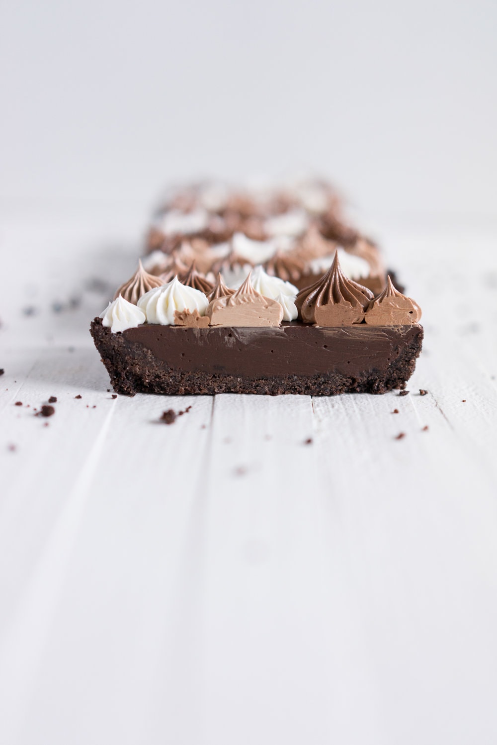 Milk Chocolate Earl Grey Tart with Ombre Dark Chocolate Swiss Meringue Buttercream. A press in cookie crust is topped with a silky earl grey infused ganache filling, then finished with an ombre swiss meringue buttercream.