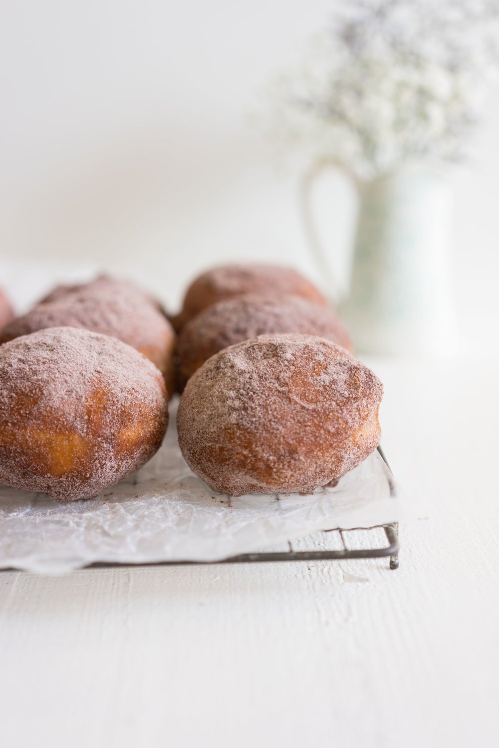 Brioche doughnuts filled with chocolate tahini pastry cream and topped with Halva