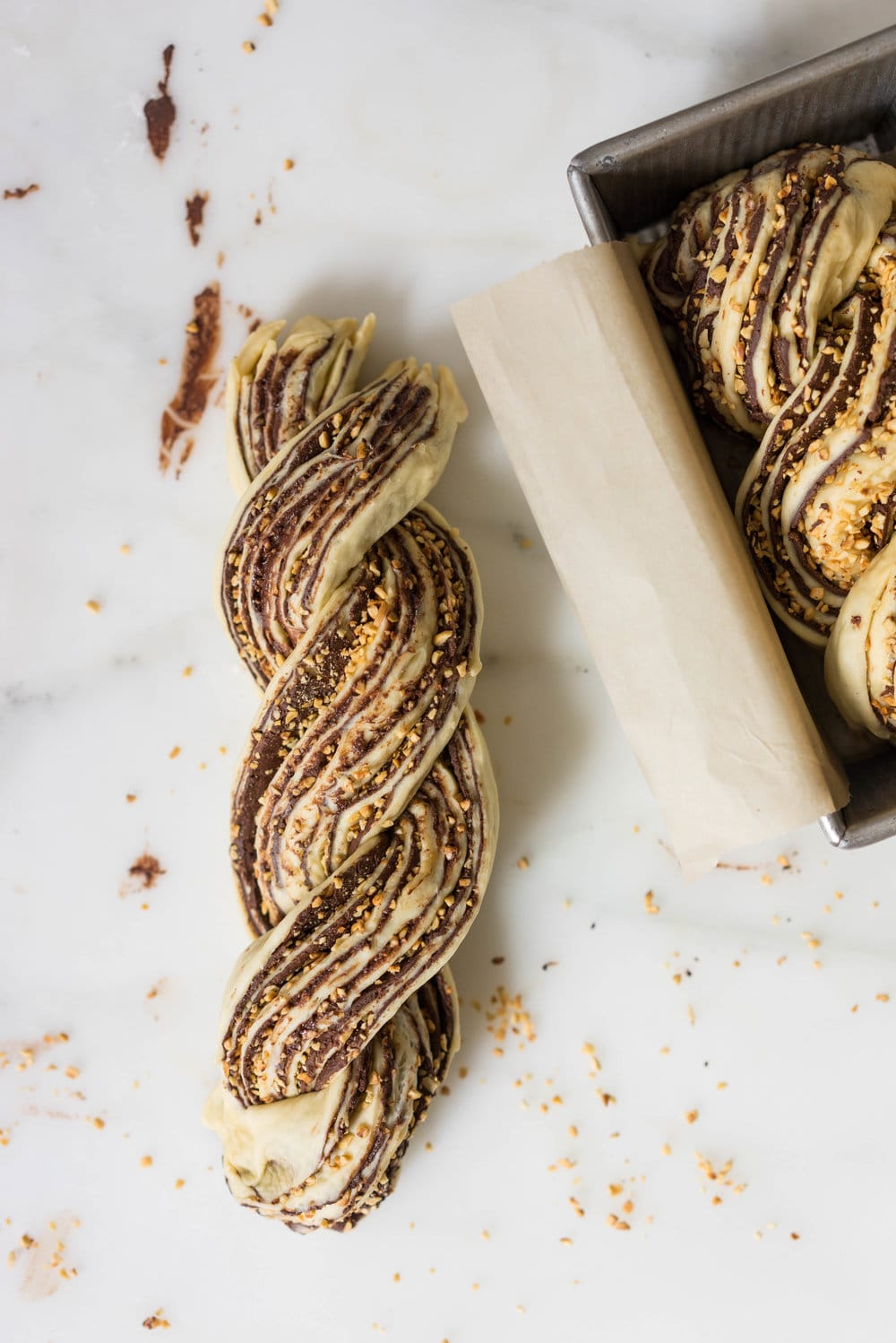 Chocolate Hazelnut Babka - fluffy brioche dough is rolled out and spread with a homemade hazelnut chocolate spread, sprinkled with chopped toasted walnuts, and rolled into swirly chocolatey loaves. The result is perfect for a coffee break, or an indulgent wee breakfast.