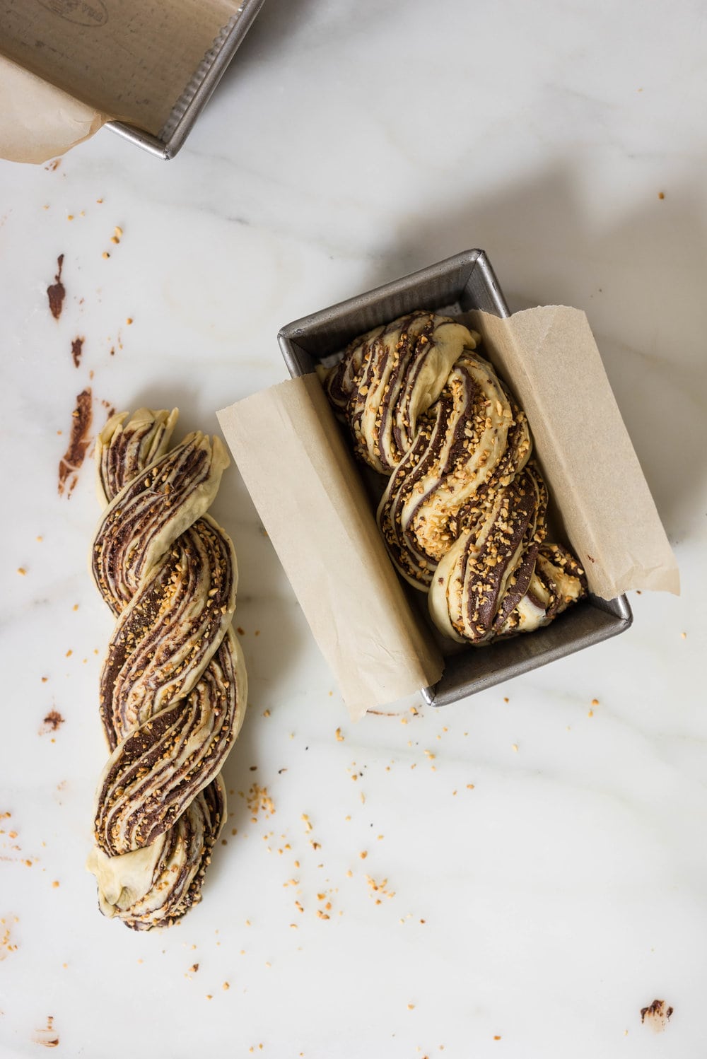Chocolate Hazelnut Babka - fluffy brioche dough is rolled out and spread with a homemade hazelnut chocolate spread, sprinkled with chopped toasted walnuts, and rolled into swirly chocolatey loaves. The result is perfect for a coffee break, or an indulgent wee breakfast.