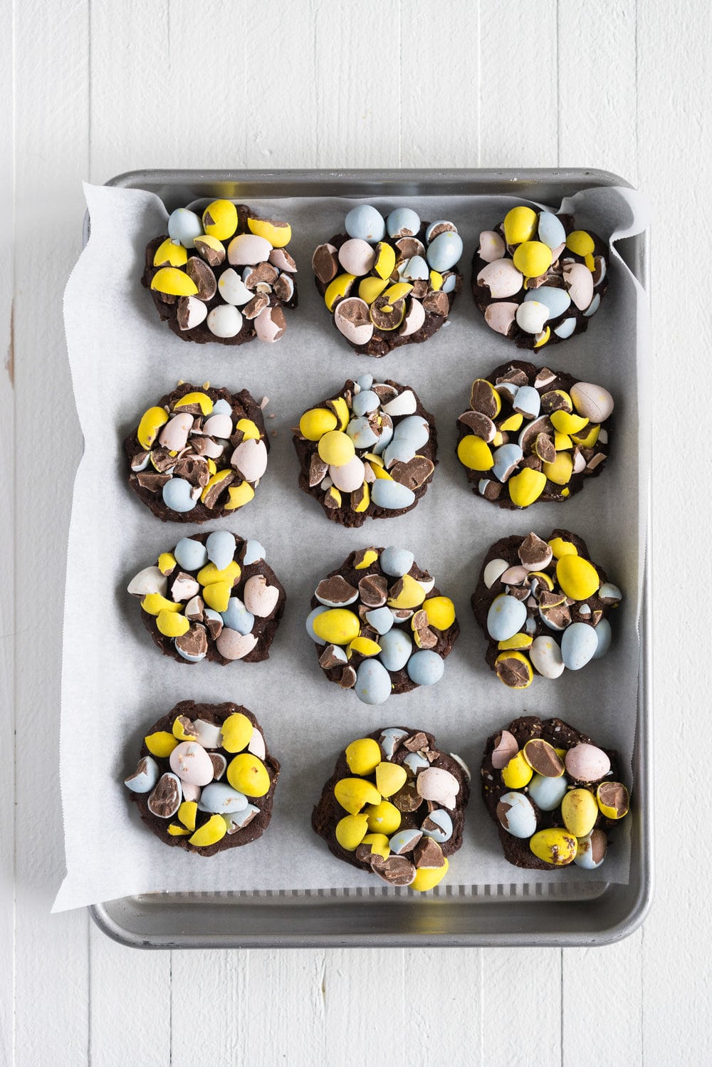 Milk Chocolate Mini Egg Cookies - the perfect addition to your easter baking schedule. These come together quickly, are super fun to make, and insanely delicious. Fudgy and chewy, chocolately and crispy, and loaded up with mini eggs.