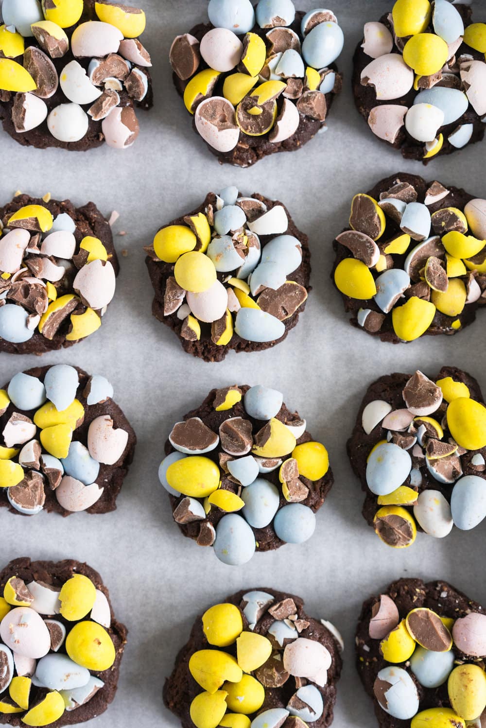 Milk Chocolate Mini Egg Cookies - the perfect addition to your easter baking schedule. These come together quickly, are super fun to make, and insanely delicious. Fudgy and chewy, chocolately and crispy, and loaded up with mini eggs.