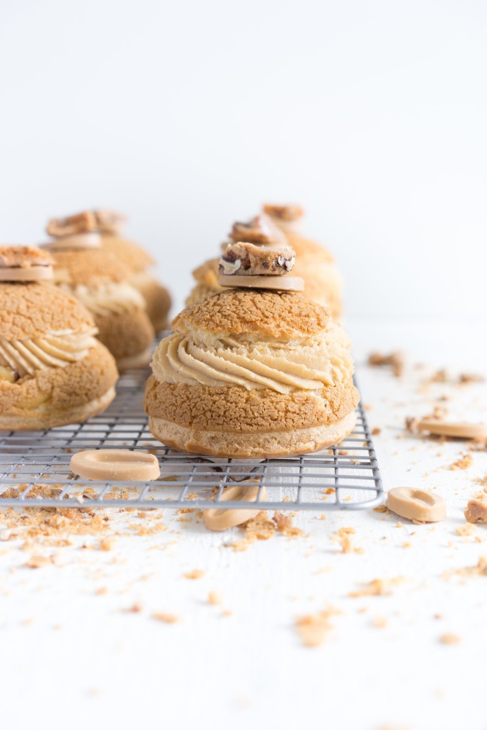 Choux au Craquelin (Cream Puffs) with Caramelised White Chocolate Whipping Ganache, Caramelised Bananas, and Pecan Brittle