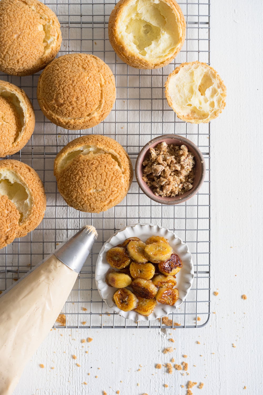 Choux au Craquelin (Cream Puffs) with Caramelised White Chocolate Whipping Ganache, Caramelised Bananas, and Pecan Brittle