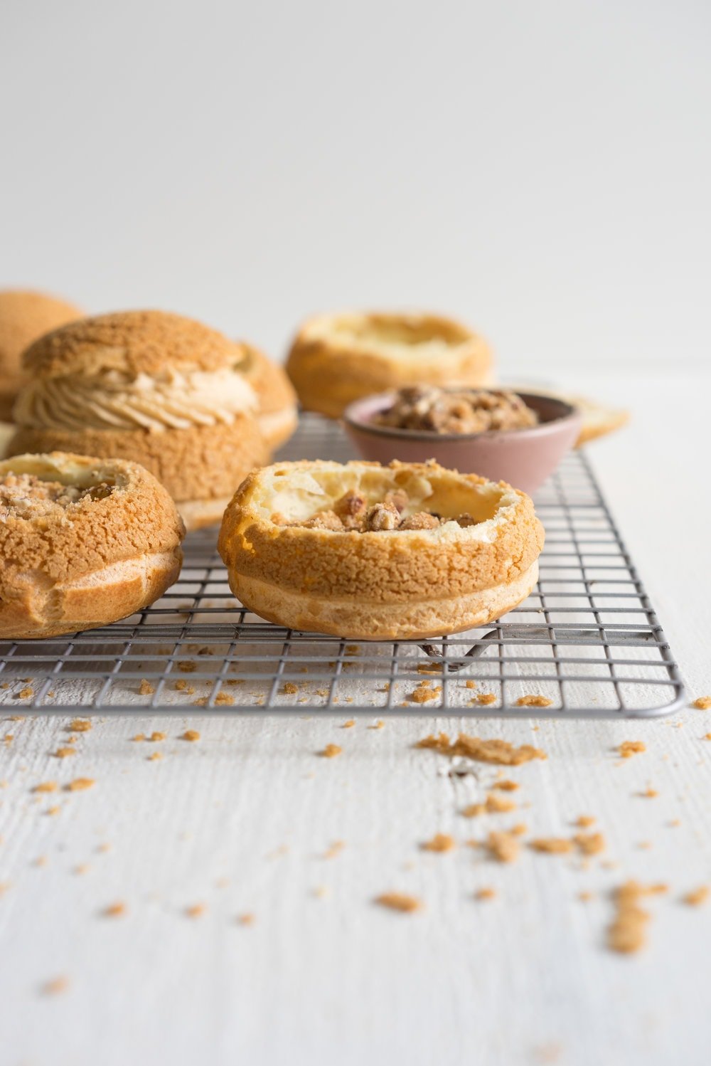 Choux au Craquelin (Cream Puffs) with Caramelised White Chocolate Whipping Ganache, Caramelised Bananas, and Pecan Brittle