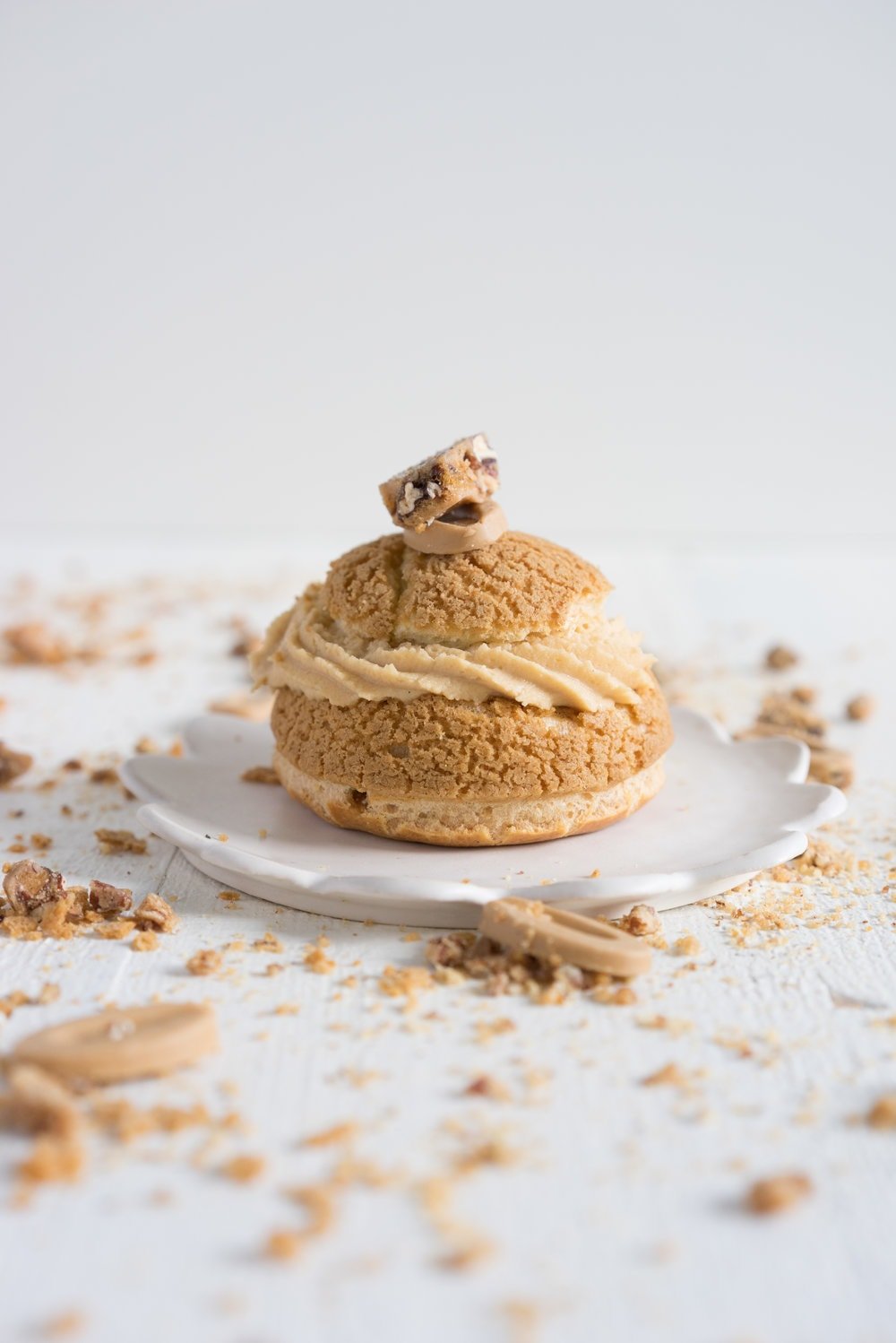Choux au Craquelin (Cream Puffs) with Caramelised White Chocolate Whipping Ganache, Caramelised Bananas, and Pecan Brittle
