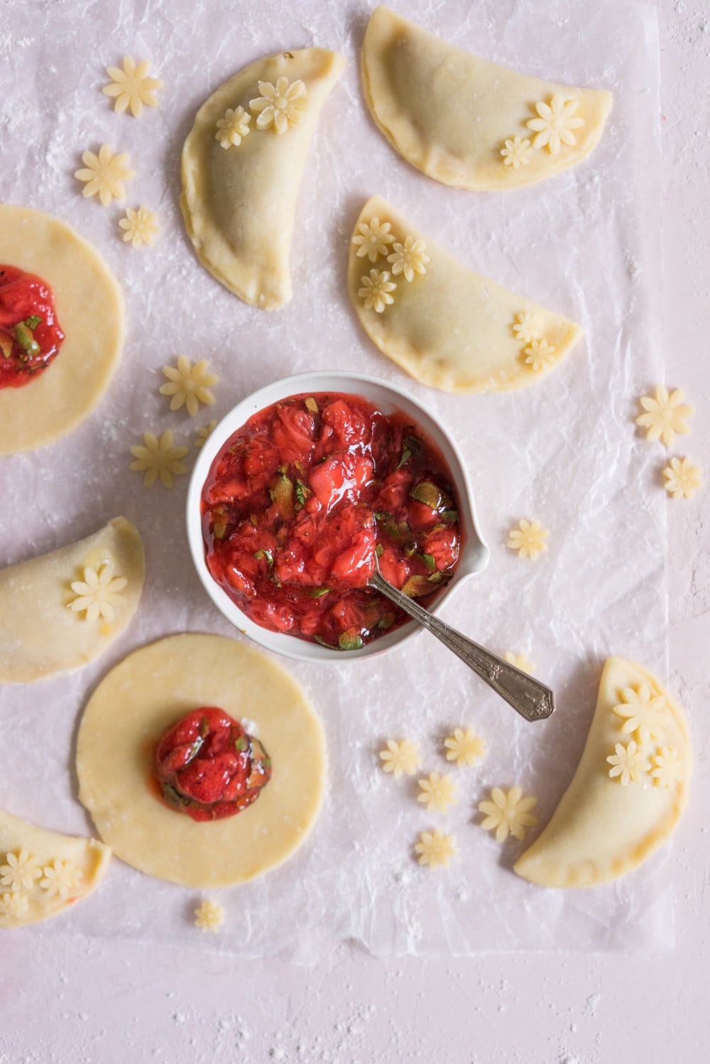 Strawberry Basil Hand Pies - Strawberries are cooked down with basil and black pepper until they are perfectly jammy, then enclosed in tender flaky pie dough. The perfect summer treat. #Strawberry #Basil #Handpie