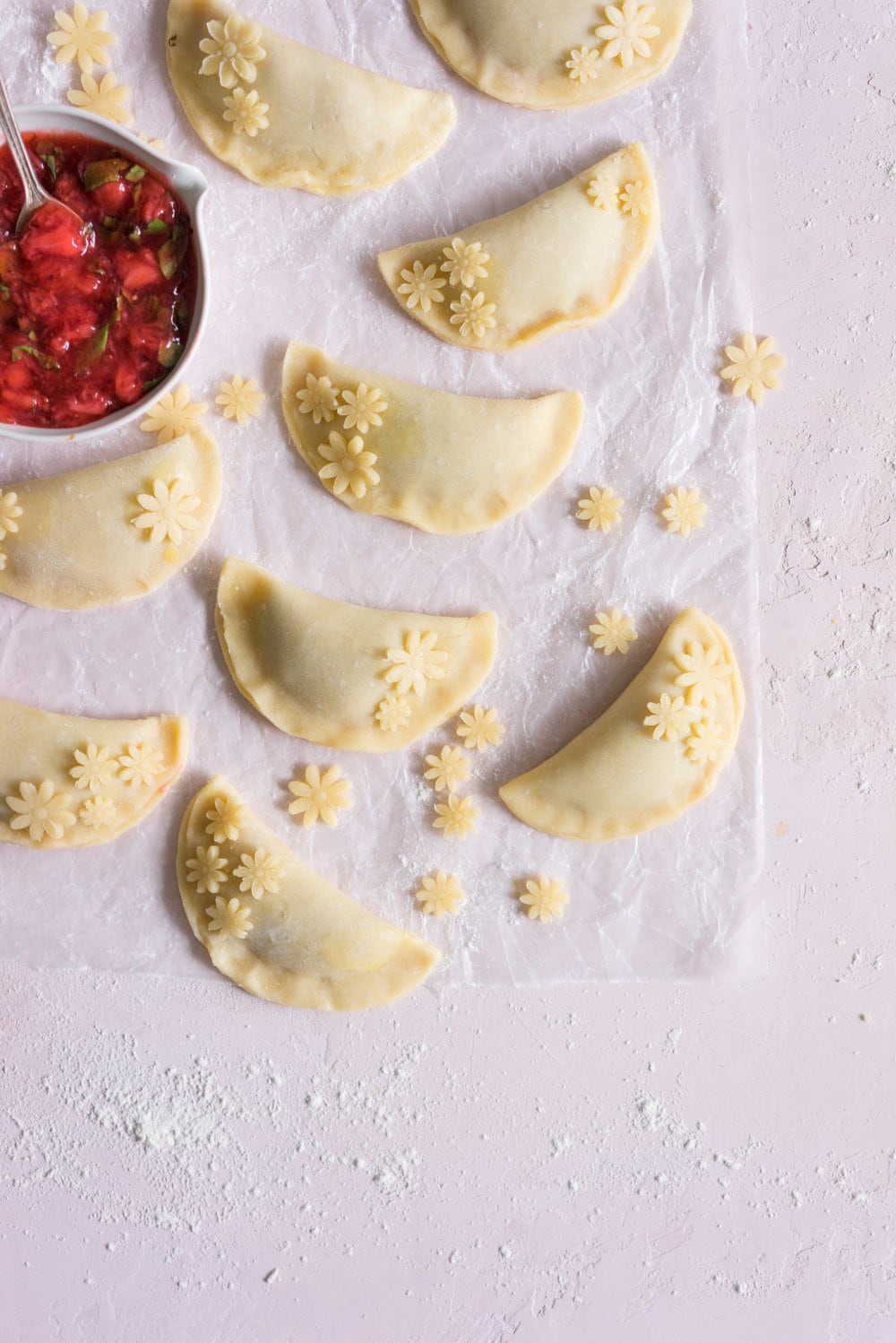 Strawberry Basil Hand Pies - Strawberries are cooked down with basil and black pepper until they are perfectly jammy, then enclosed in tender flaky pie dough. The perfect summer treat. #Strawberry #Basil #Handpie
