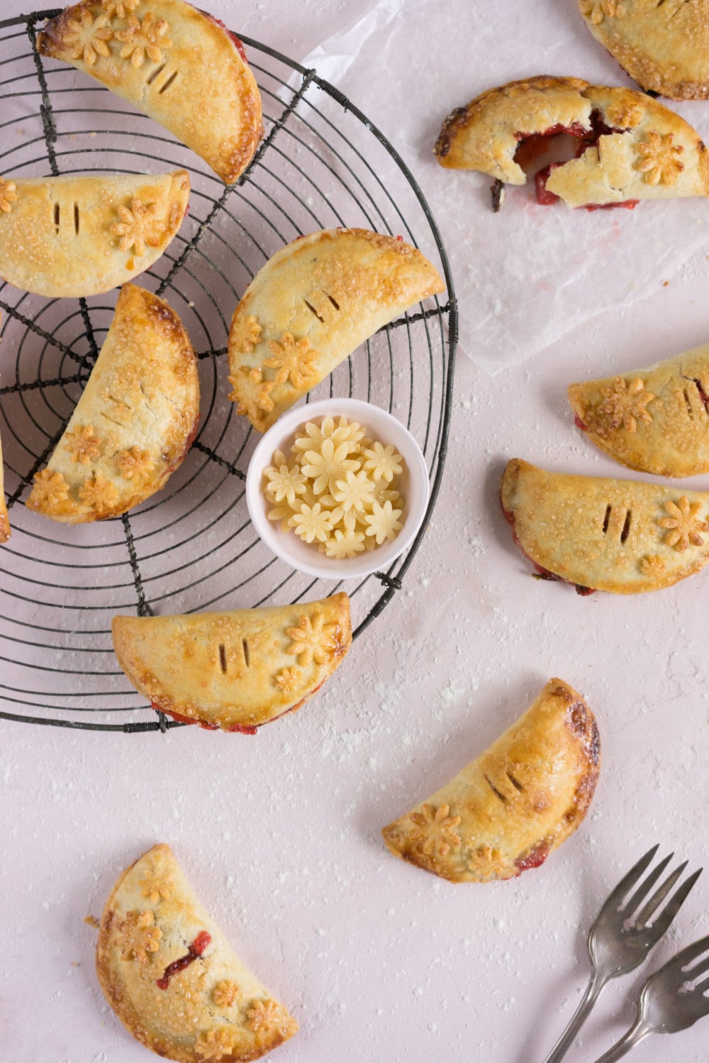 Strawberry Basil Hand Pies - Strawberries are cooked down with basil and black pepper until they are perfectly jammy, then enclosed in tender flaky pie dough. The perfect summer treat. #Strawberry #Basil #Handpie
