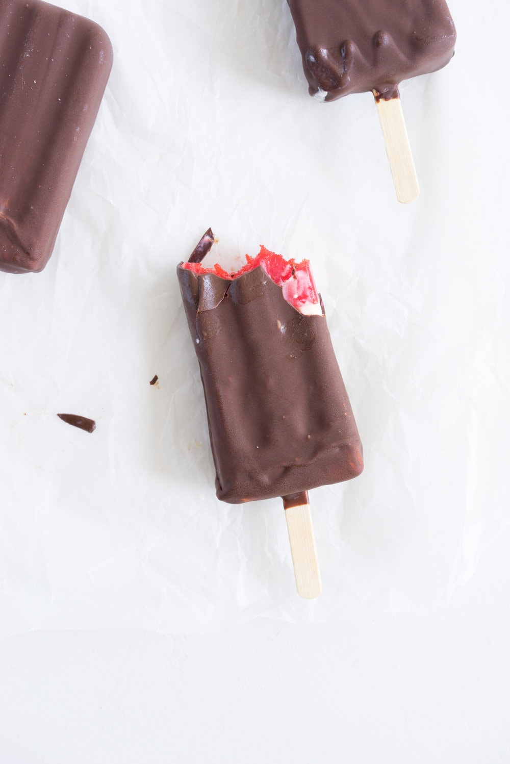 A homemade take on the New Zealand Childhood favourite Jelly Tips - the top of ice cream pops are filled with jelly before being topped up with creamy vanilla bean ice cream, then dipped in a dark chocolate topping.