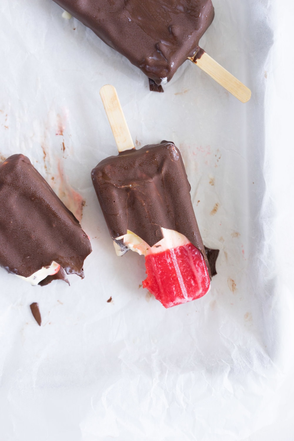 A homemade take on the New Zealand Childhood favourite Jelly Tips - the top of ice cream pops are filled with jelly before being topped up with creamy vanilla bean ice cream, then dipped in a dark chocolate topping.