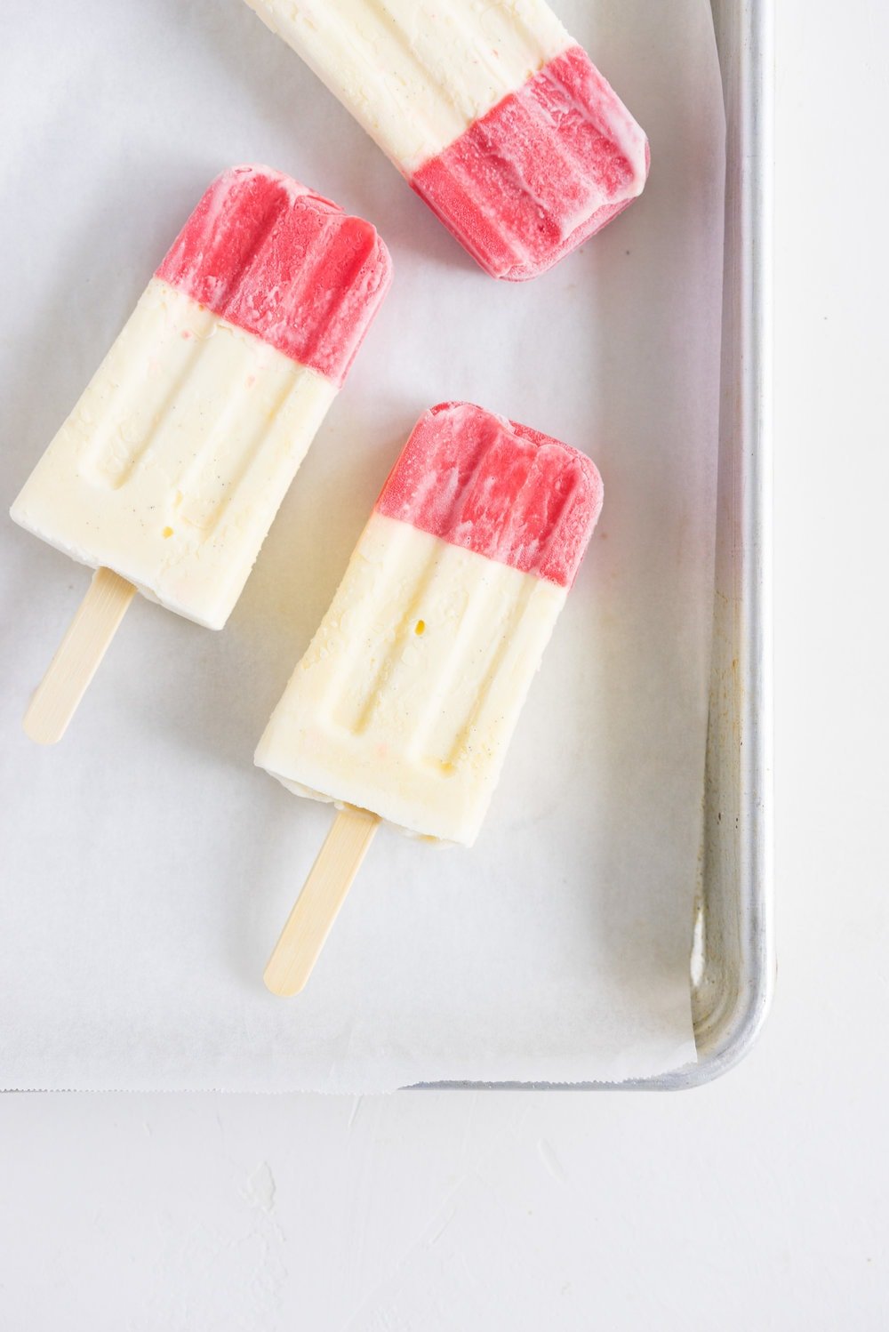 A homemade take on the New Zealand Childhood favourite Jelly Tips - the top of ice cream pops are filled with jelly before being topped up with creamy vanilla bean ice cream, then dipped in a dark chocolate topping.
