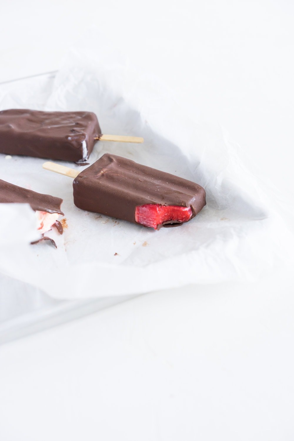 A homemade take on the New Zealand Childhood favourite Jelly Tips - the top of ice cream pops are filled with jelly before being topped up with creamy vanilla bean ice cream, then dipped in a dark chocolate topping.
